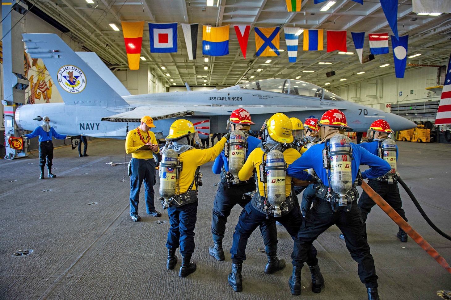 Sailors fight a simulated fire during a general quarters drill aboard Nimitz-class aircraft carrier USS Carl Vinson (CVN 70). Vinson is currently pier-side in its homeport of San Diego.