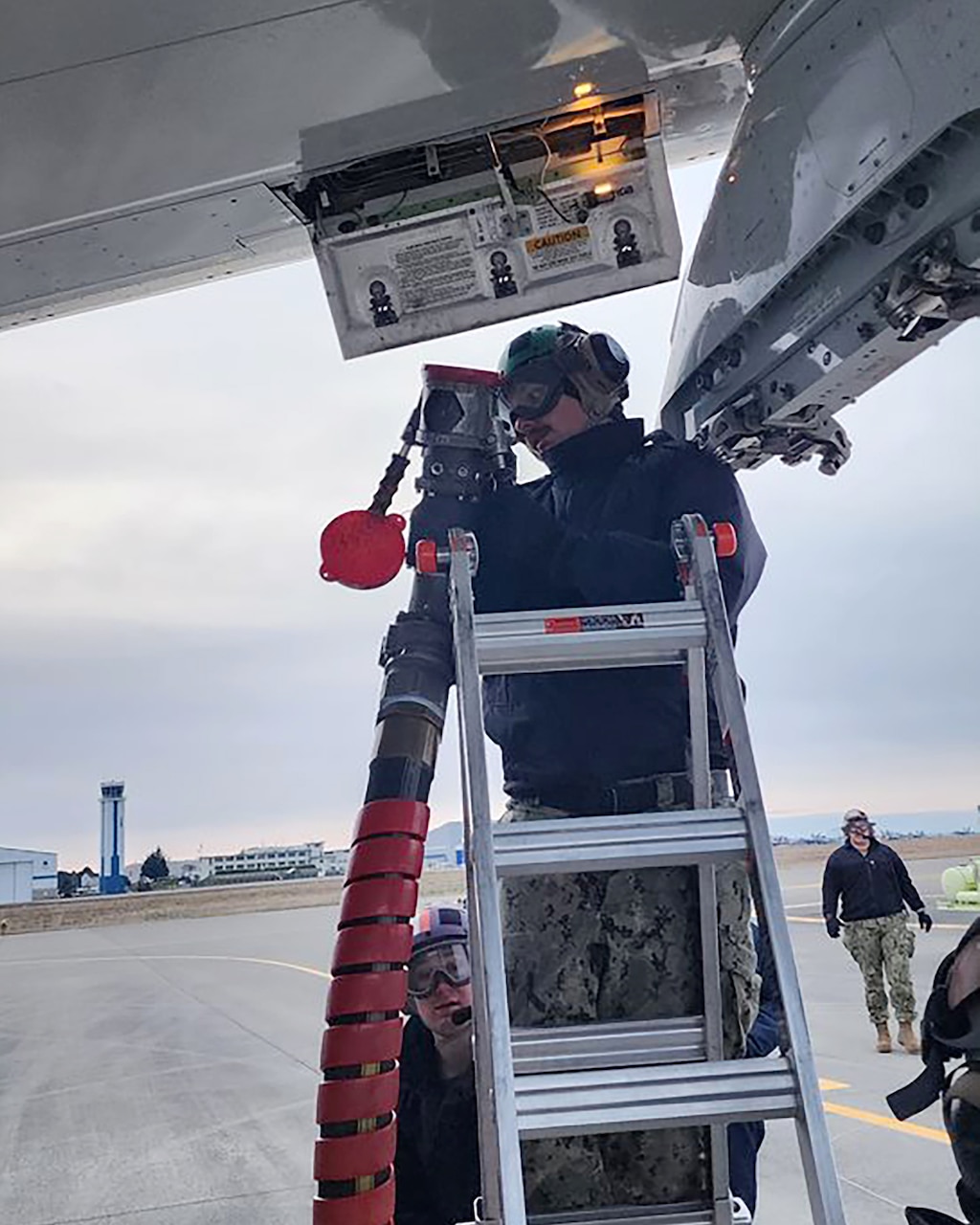 Sailors from NAVSUP Fleet Logistics Center Puget Sound perform the first-ever 'hot' refueling of a P-8 Poseidon aircraft at Naval Air Station Whidbey Island.  The aircraft taxis to a 'hot pit' on on the flight line where it is refueled while the engines continue to operate.  This expanded capability reduces down time and allows the aircraft to return to mission at a faster rate.