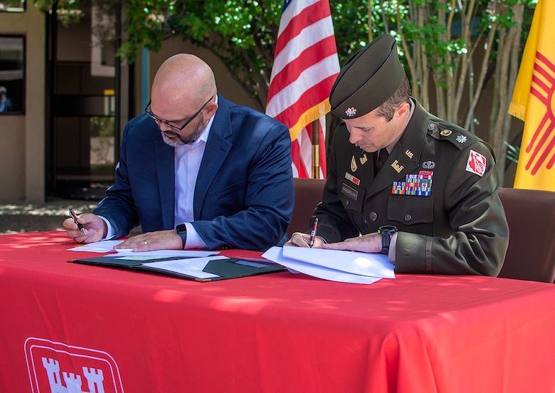 Lt. Col. Jerre Hansbrough (right), commander, USACE-Albuquerque District, and Jason Casuga, chief engineer and CEO of the MRGCD, sign a design agreement for the Middle Rio Grande, Bernalillo to Belen, flood control project, June 13, 2023.
