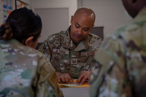 A photo of an Airman sealing an envelope.