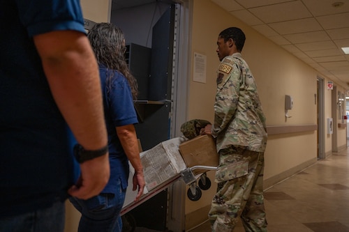 A photo of an Airman transporting mail.