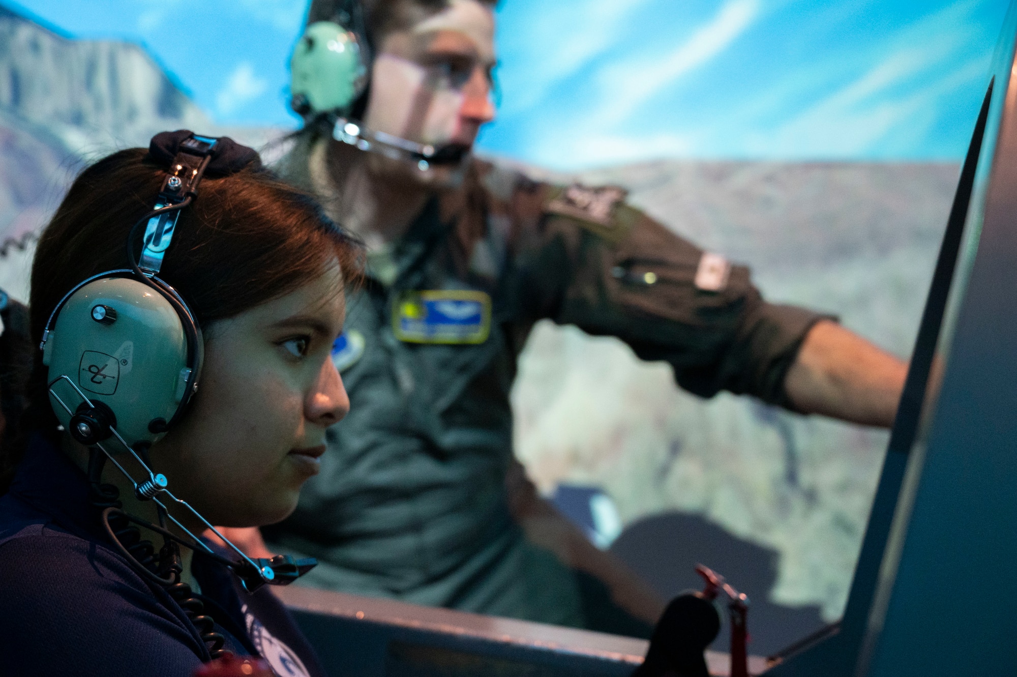 Carla Robles (front), Del Rio High School Junior Reserve Officer’s Training Corps cadet, is lead by U.S. Air Force Capt. John Champagne (behind), 85th Flying Training Squadron flight simulator instructor, through a T-6A Texan II flight simulator at Laughlin Air Force Base, Texas, June 7, 2023. Under the guidance of Col. Kevin Davidson, 47th Flying Training Wing commander, Robles visited Laughlin to learn the valuable insights into the leadership required to steer Laughlin’s service members towards mission success. (U.S. Air Force photo by Airman 1st Class Kailee Reynolds)