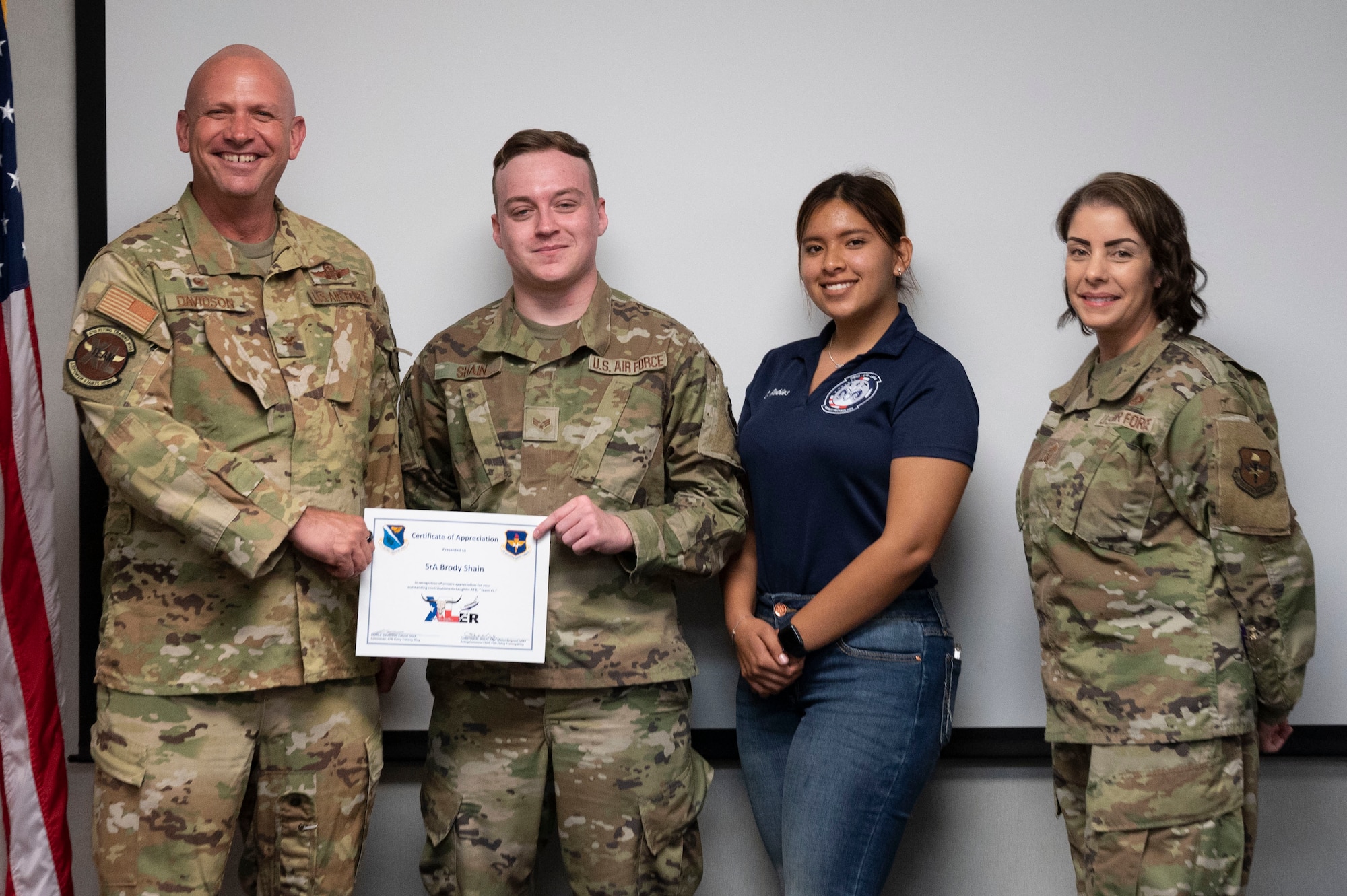Carla Robles, (middle right), Del Rio High School Junior Reserve Officer’s Training Corps cadet, poses for a photo with Col. Kevin Davidson (left), 47th Flying Training Wing commander, and Chief Master Sgt. Christina Wolfe (right), 47th Operations Group senior enlisted leader, and Weekly Xler award recipient Senior Airman Brody Shain, 47th Healthcare Operations Squadron medical logistics technician, at Laughlin Air Force Base, Texas, June 7, 2023. Robles visited Laughlin to gain insight into strategic decision-making, personnel management, and the execution of critical missions under the guidance of Col. Kevin Davidson, 47th Flying Training Wing commander. (U.S. Air Force photo by Airman 1st Class Kailee Reynolds)