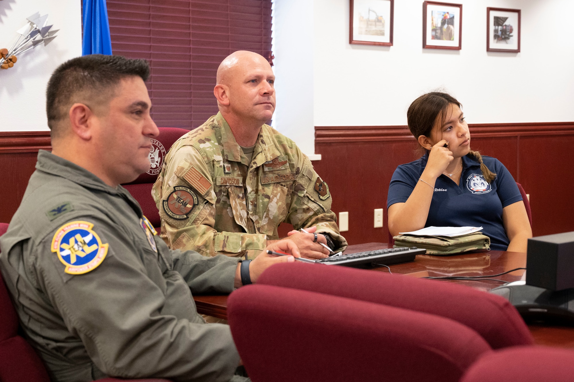 Carla Robles (right), Del Rio High School Junior Reserve Officer’s Training Corps cadet, joins Col. Kevin Davidson (middle), 47th Flying Training Wing commander, and Col. Andrew Katz (left), 47th Flying Training Wing vice commander, to a staff meeting at Laughlin Air Force Base, Texas, June 7, 2023. Robles joined Davidson and other leaders to discuss the many responsibilities of ensuring mission success and Airmen professional development. (U.S. Air Force photo by Airman 1st Class Kailee Reynolds)