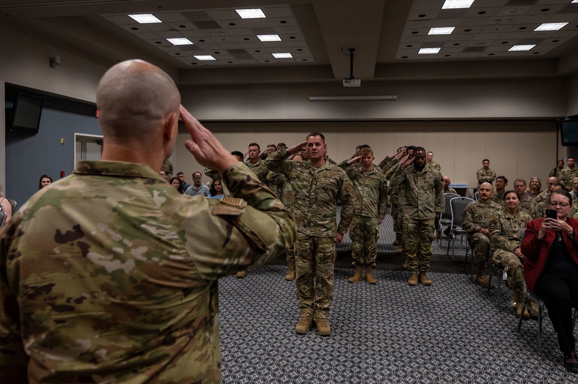 A Member of the 17th Security Forces Squadron salutes U.S. Air Force Maj. Jeremy S. Berger, incoming 17th Security Forces Squadron commander, during the change of command ceremony at the Powell Event Center, Goodfellow Air Force Base, Texas, June 15, 2023. The salute represents the squadron welcoming its new commander. (U.S. Air Force photo by Staff Sgt. Jermaine Ayers)