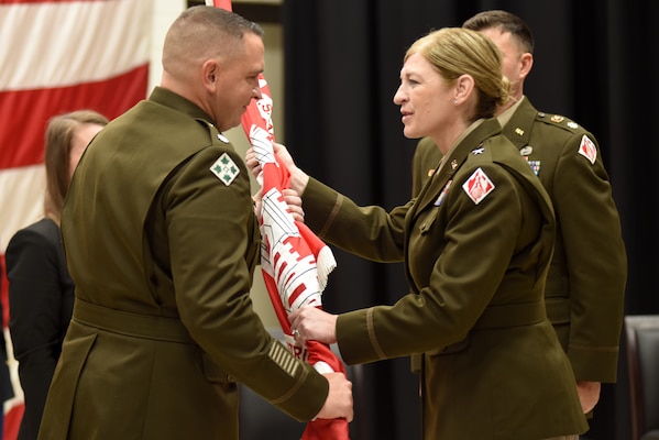 Brig. Gen. Kimberly A. Peeples (Right), U.S. Army Corps of Engineers Great Lakes and Ohio River Division commander, passes the Nashville District flag to Lt. Col. Robert W. Green as he took command of the Nashville District during a change of command ceremony June 16, 2023, at the Tennessee National Guard Armory in Nashville, Tennessee. (USACE photo by Lee Roberts)