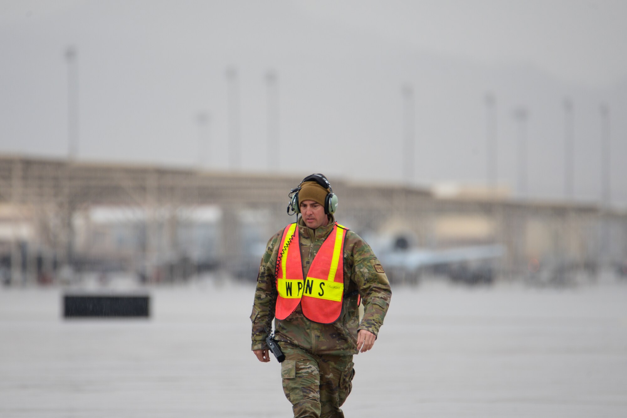 A photo of Tech. Sgt. Greg Rivera walking on a flight line.