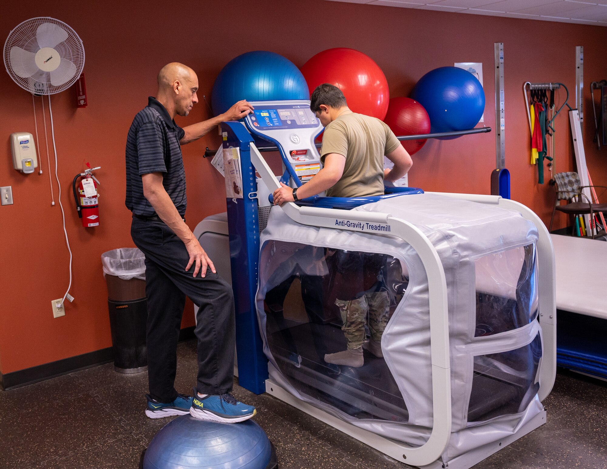 Percel Crudup, 56th Medical Group physical therapy assistant, assists U.S. Air Force Airman 1st Class Elias Carrero, 56th Fighter Wing public affairs specialist, while he runs on an Anti-Gravity Treadmill, June 15, 2023, at Luke Air Force Base, Arizona.