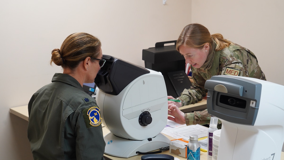 Staff Sgt. Kristin Fernandez (right), 88th Operational Medical Readiness Squadron flight and operational medicine technician, administers an eye test to an Airman at Wright-Patterson Medical Center’s Flight Medicine Clinic, June 13, 2023. The squadron “dominates the dirty work” by ensuring Airmen and military members are medically ready to execute their missions in home-base and deployed locations. (U.S. Air Force photo by Kenneth J. Stiles)