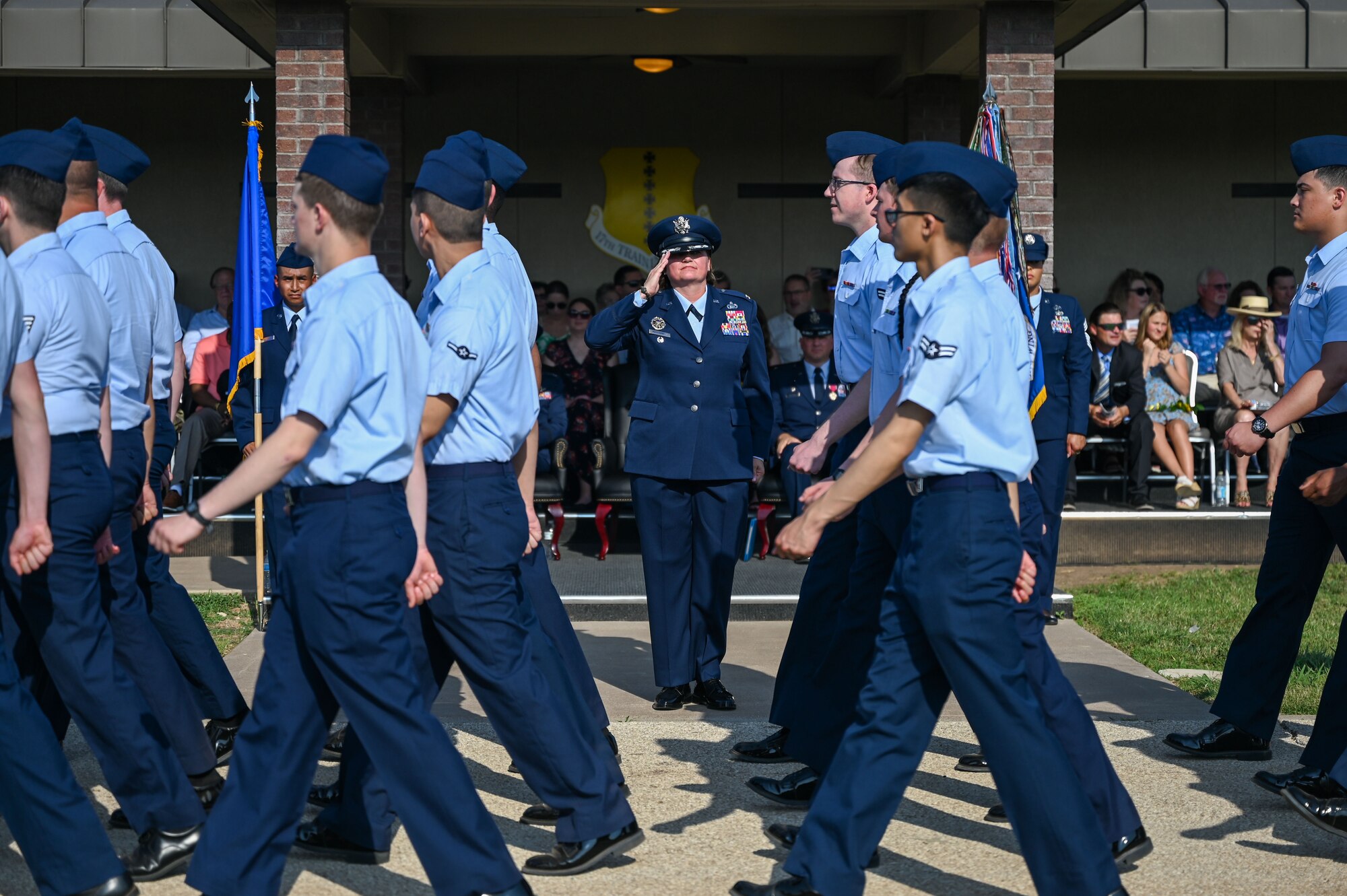 U.S. Air Force Airmen assigned to the 17th Training Wing conduct a Pass in Review to U.S. Air Force Col. Angelina Maguinness, 17th TRW commander, during the change of command ceremony at Goodfellow Air Force Base, Texas, June 16, 2023. The salute represents the squadron welcoming its new commander. (U.S. Air Force photo by Senior Airman Sarah Williams)