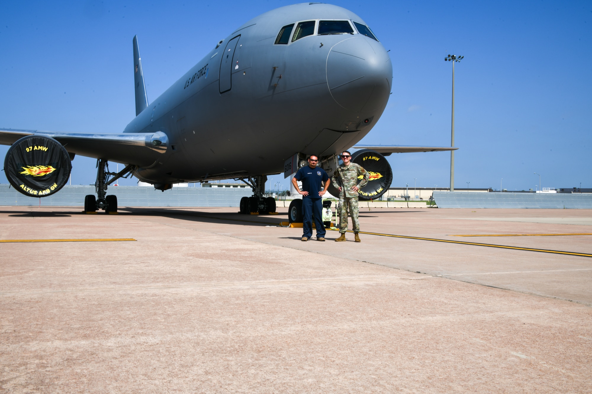 U.S. Air Force Staff Sgt. Bryson Fry, 97th Logistics Readiness Squadron ground transporter, poses in front of a KC-46 Pegasus with his father, Branden Fry, 97th Aircraft Maintenance Squadron hydraulics systems mechanic at Altus Air Force Base, Oklahoma, June 15, 2023. Bryson was inspired by his father to join the military. (U.S. Air Force photo by Airman 1st Class Miyah Gray)