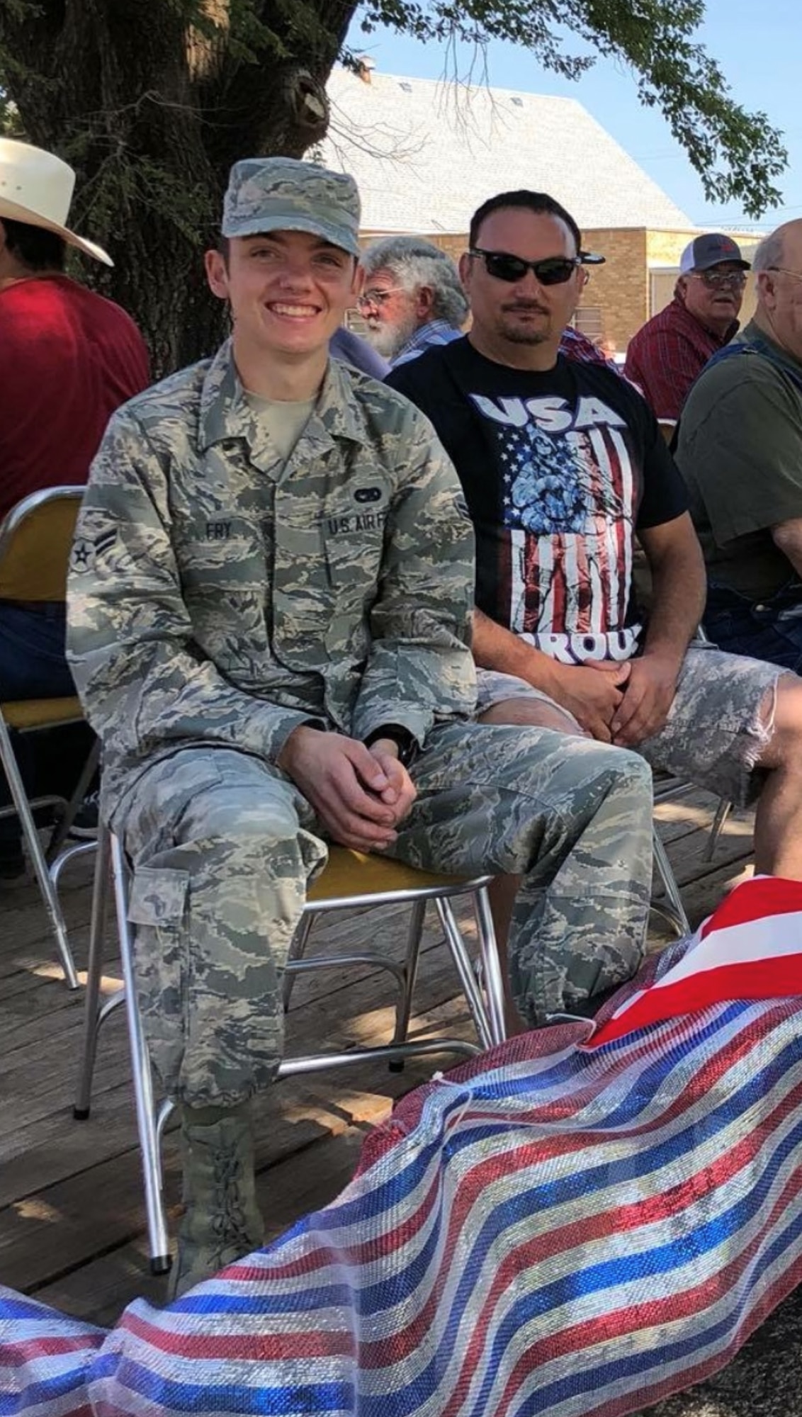 U.S. Air Force Staff Sgt. Bryson Fry, 97th Logistics Readiness Squadron ground transporter, pictured here as an Airman 1st Class, poses with his father, Branden Fry, 97th Aircraft Maintenance Squadron hydraulics systems mechanic, during an Independence Day parade in Sentinel, Oklahoma, July 4, 2019. Branden and Bryson both joined the military immediately after graduating high school. (Courtesy photo by Branden Fry)