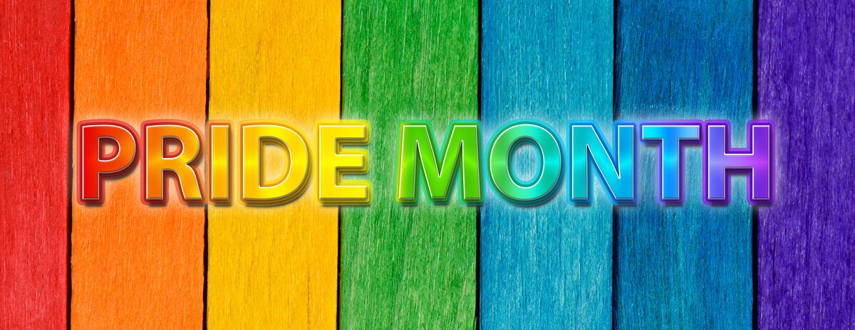 Photo of rainbow LGBT plus pride flag crafted from painted wooden boards in rainbow colors with rainbow Pride Month text overlay. Modified Graphic © NikonLamp/stock.adobe.com [image is not public domain]