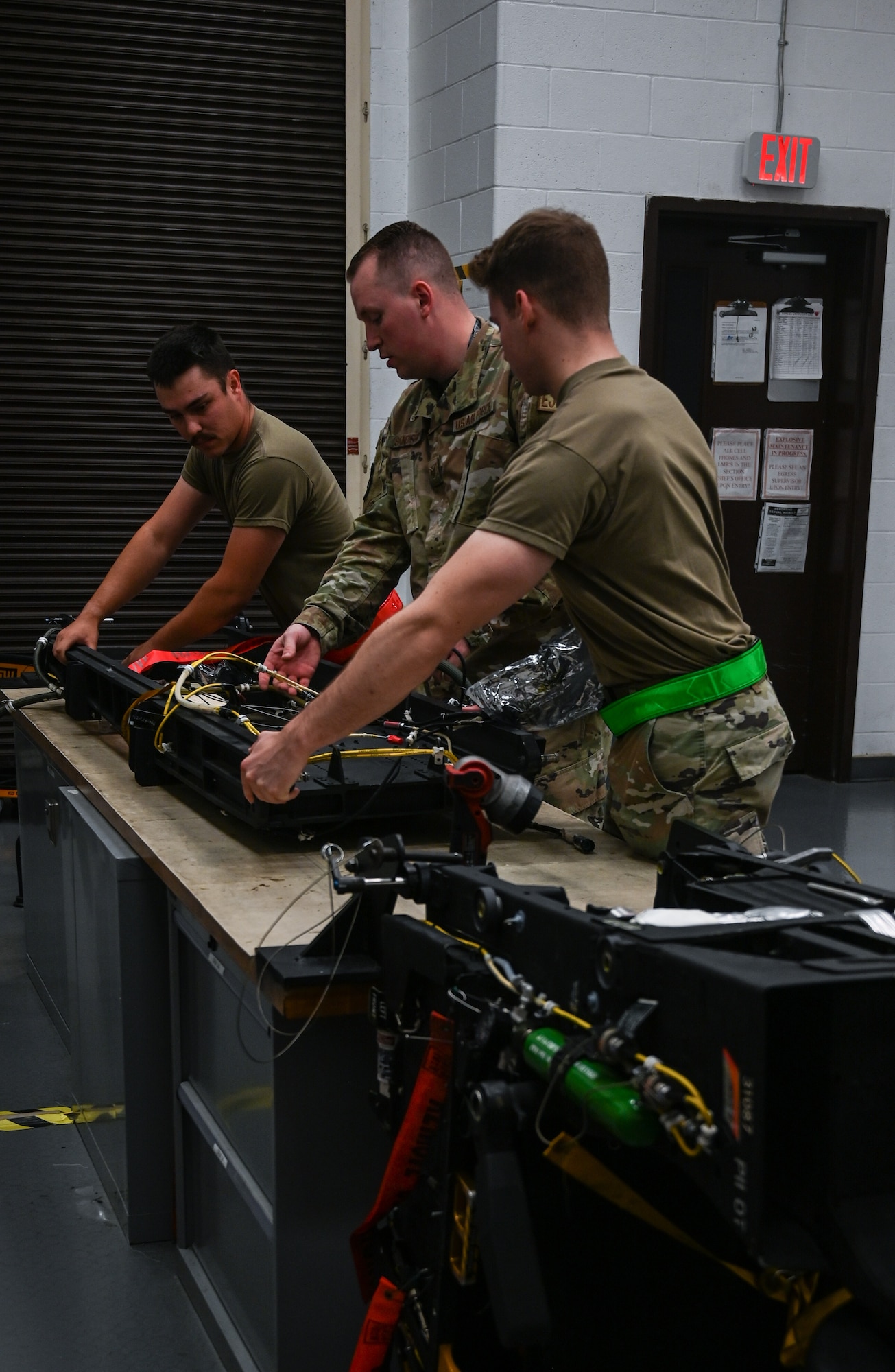 U.S. Air Force Airmen assigned to the 509th Maintenance Squadron aircrew egress section set up a B-2 Spirit ejection training seat at Whiteman Air Force Base, Missouri, June 15, 2023. Egress is the system that controls the seats ejecting out of the B-2, in the case of an emergency, requiring the pilot and mission commander to get out of the aircraft in a hurry. (U.S. Air Force photo by Senior Airman Victoria Hommel)