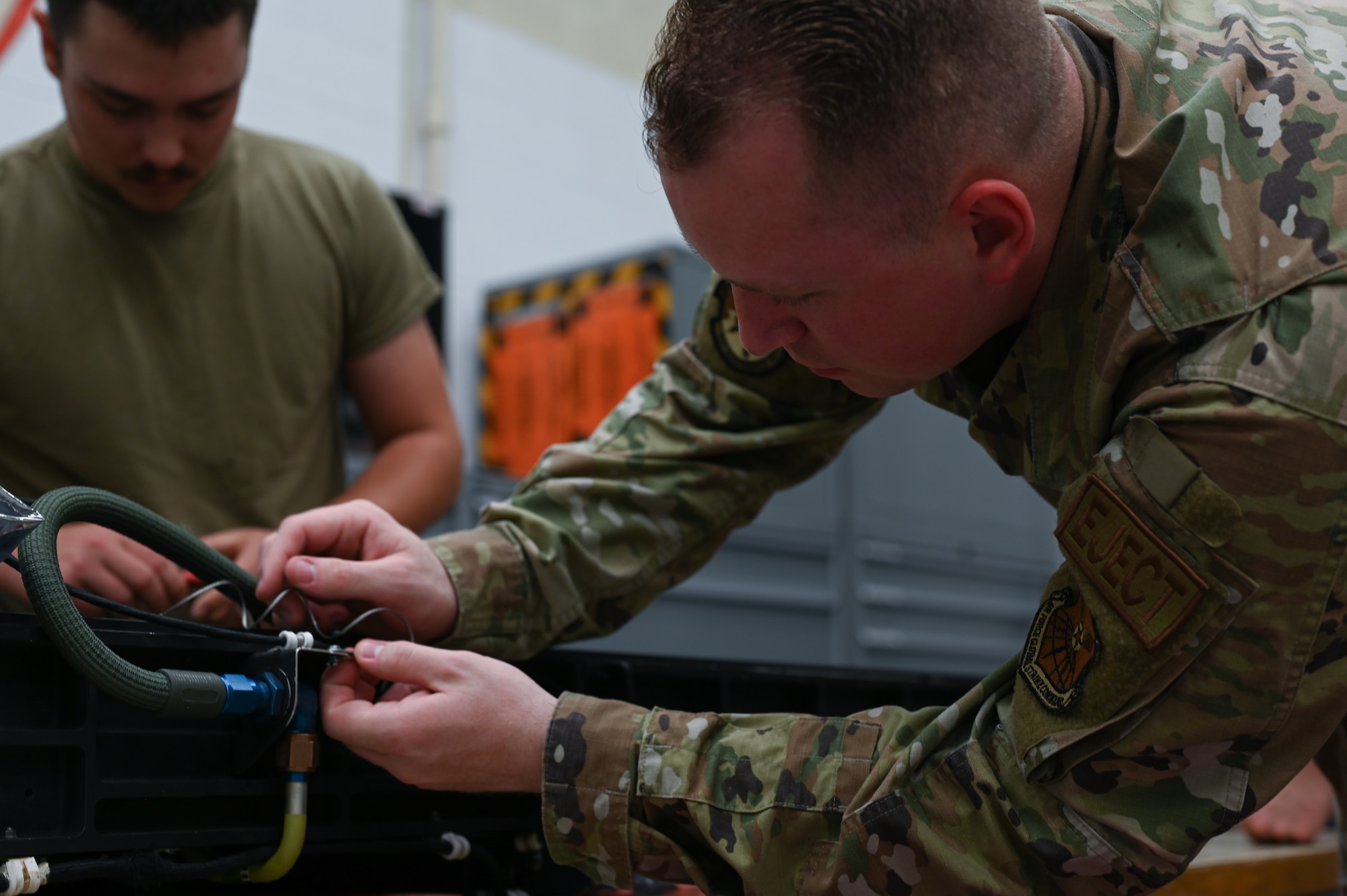 U.S. Air Force Staff Sgt. Marcus Sandifer, 509th Maintenance Squadron egress section non-commissioned officer in charge, inspects a B-2 Spirit ejection training seat at Whiteman Air Force Base, Missouri, June 15, 2023. Egress is the system that controls the seats ejecting out of the B-2, in the case of an emergency, requiring the pilot and mission commander to get out of the aircraft in a hurry. (U.S. Air Force photo by Senior Airman Victoria Hommel)