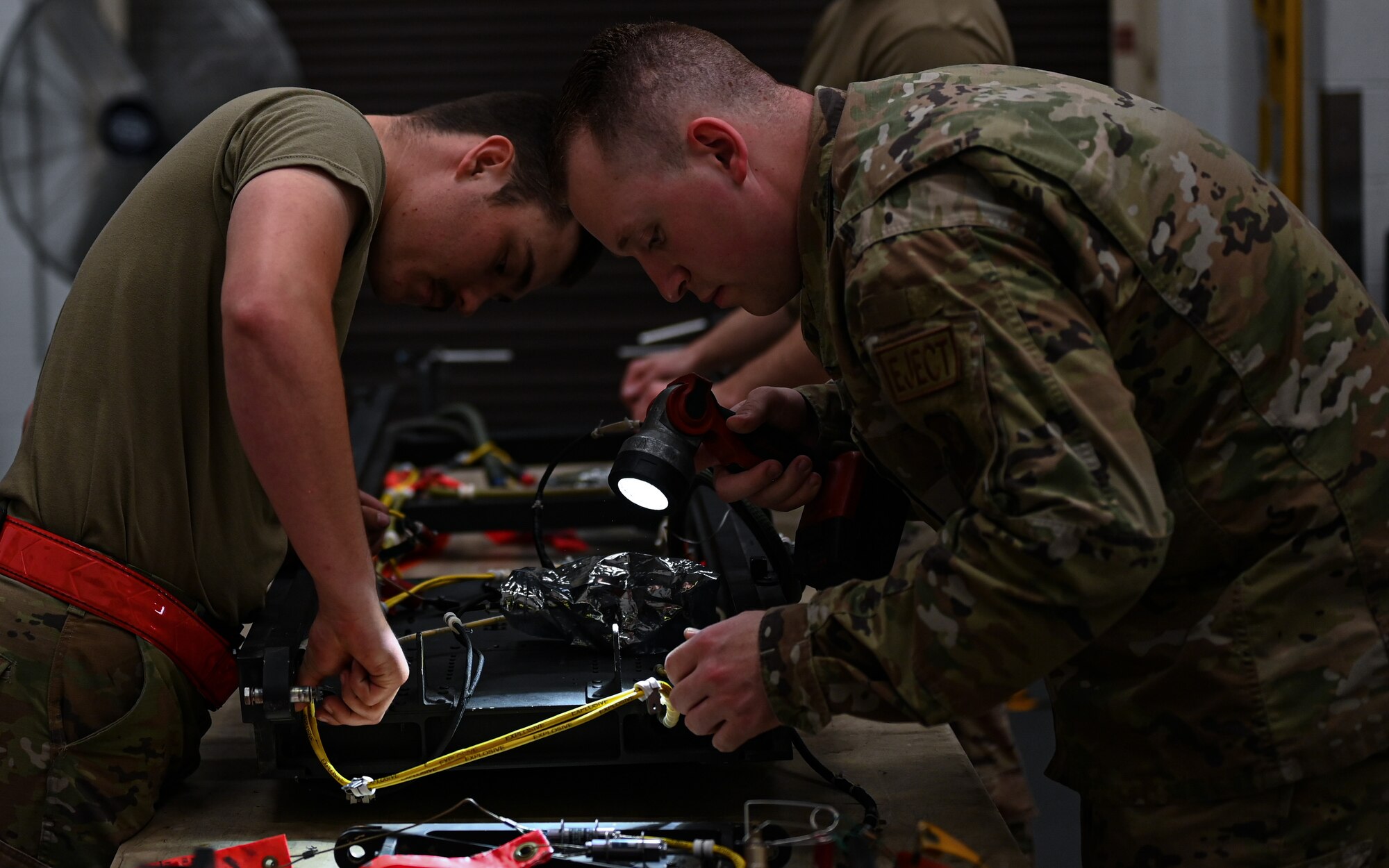 U.S. Air Force Staff Sgt. Marcus Sandifer, 509th Maintenance Squadron egress section non-commissioned officer in charge, inspects a B-2 Spirit ejection training seat with Airman 1st Class Korbyn Armijo-Pemble, 509th Maintenance Squadron aircrew egress journeyman, at Whiteman Air Force Base, Missouri, June 15, 2023. Egress is the system that controls the seats ejecting out of the B-2, in the case of an emergency, requiring the pilot and mission commander to get out of the aircraft in a hurry. (U.S. Air Force photo by Senior Airman Victoria Hommel)