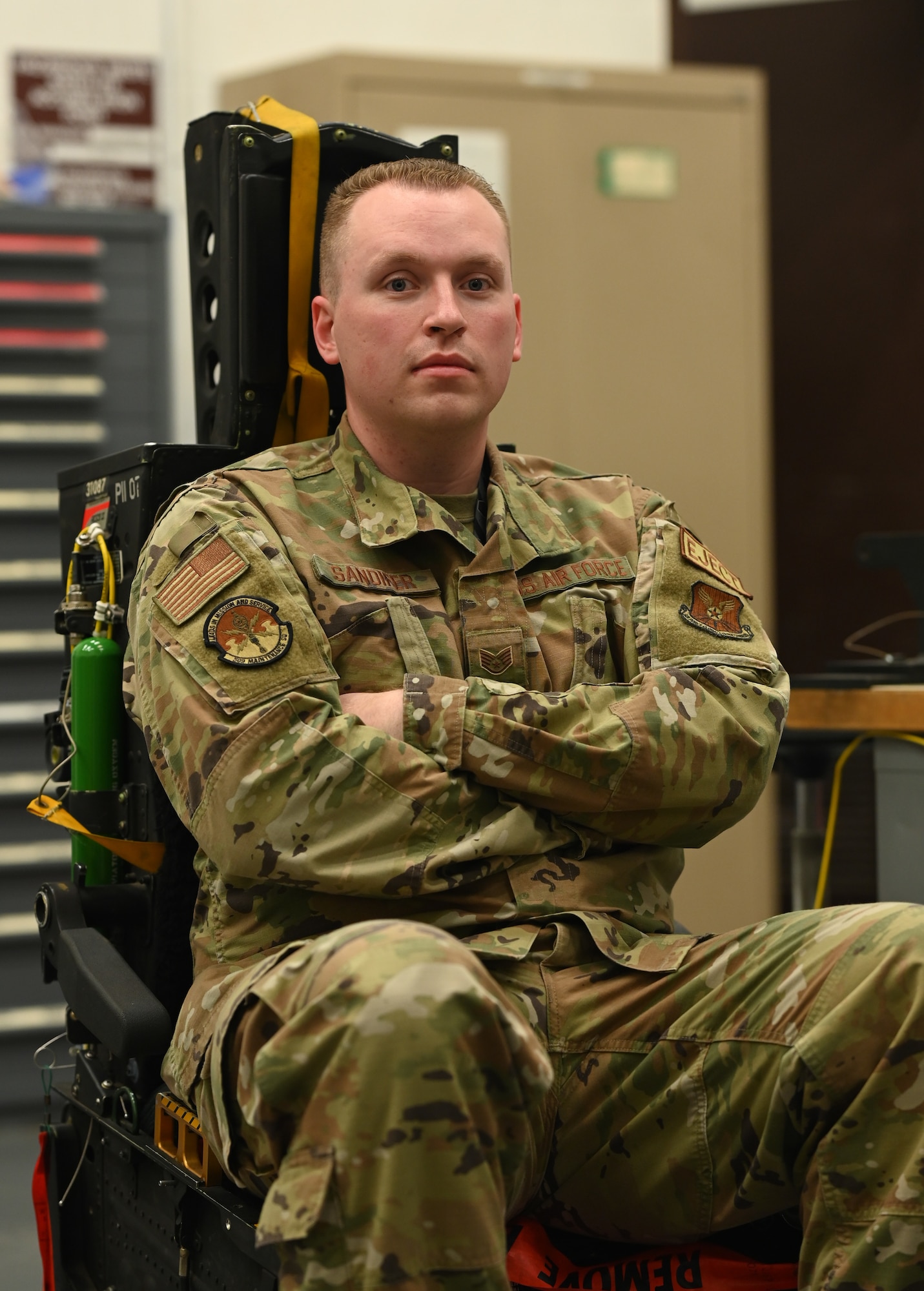 U.S. Air Force Staff Sgt. Marcus Sandifer, 509th Maintenance Squadron egress section non-commissioned officer in charge, sits in the B-2 Spirit ejection training seat at Whiteman Air Force Base, Missouri, June 15, 2023. Egress is the system that controls the seats ejecting out of the B-2, in the case of an emergency, requiring the pilot and mission commander to get out of the aircraft in a hurry. (U.S. Air Force photo by Senior Airman Victoria Hommel)