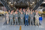 Representatives from the 12th Air Force (Air Forces Southern), the West Virginia Air National Guard, and the Peruvian Air Force gather on a C-17 Globemaster aircraft ramp after a ceremony to mark the signing of a cooperation agreement between the three entities, at the 167th Airlift Wing, Shepherd Field, Martinsburg, West Virginia, June 9, 2023.