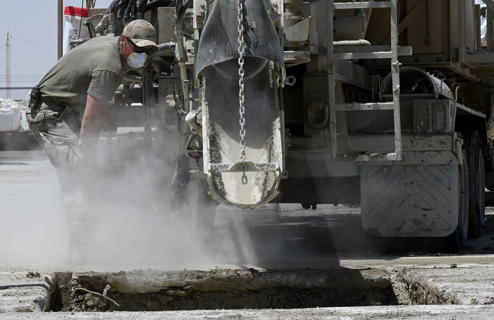 A photo of an Airman pouring concrete.