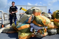 Petty Officer 3rd class Brandon New, a crew member of Coast Guard Cutter Bear stands security watch during a drug offload at Miami, Florida, June 16, 2023.
