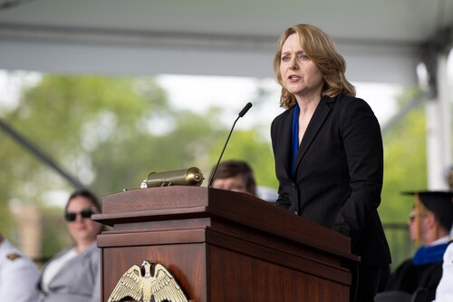 Deputy Secretary of Defense Kathleen Hicks speaks to an audience from a stage.