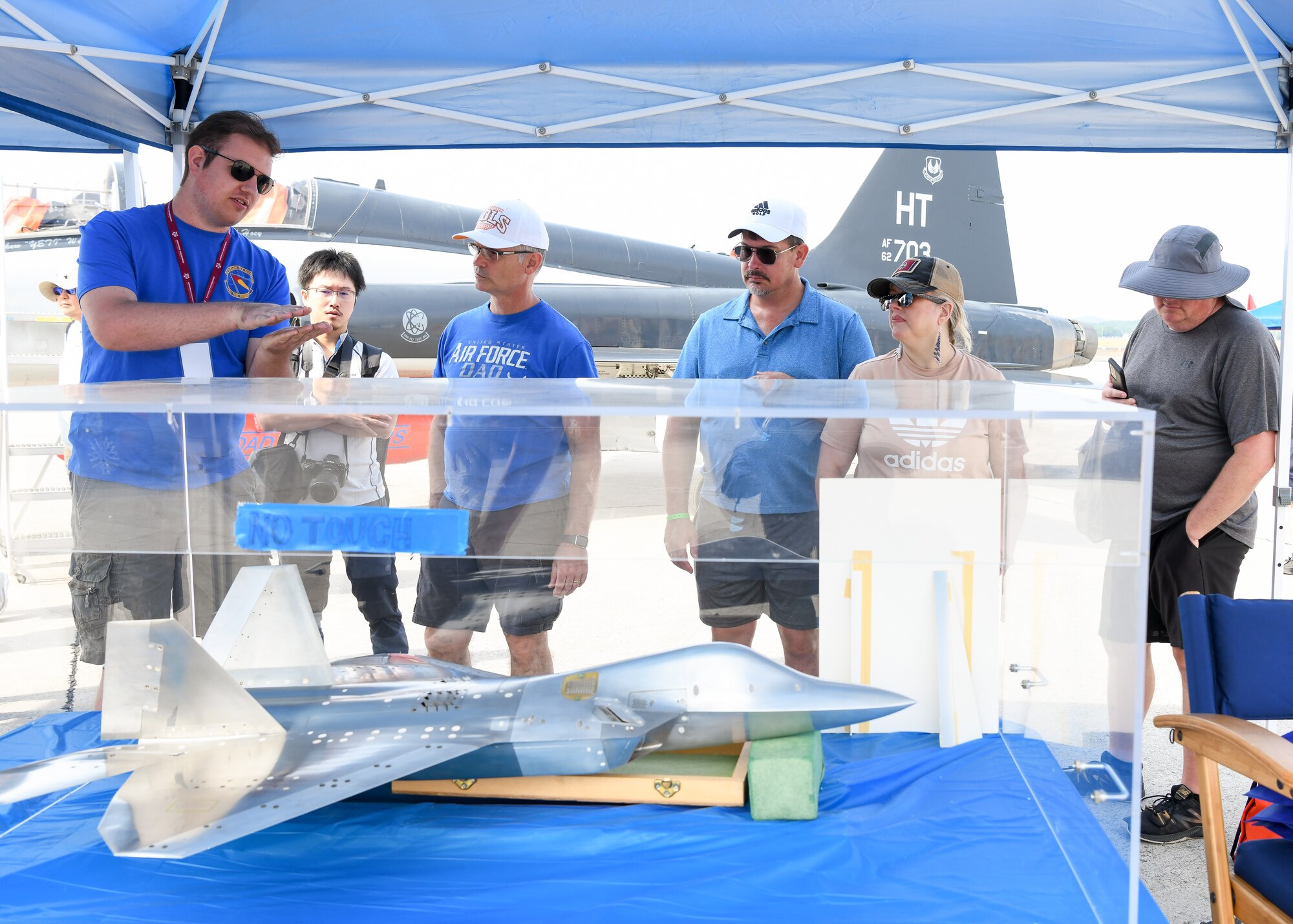 People looking at scale model of an aircraft