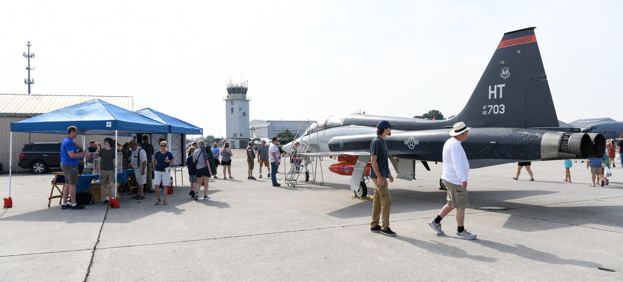 People walking by airplane at air show