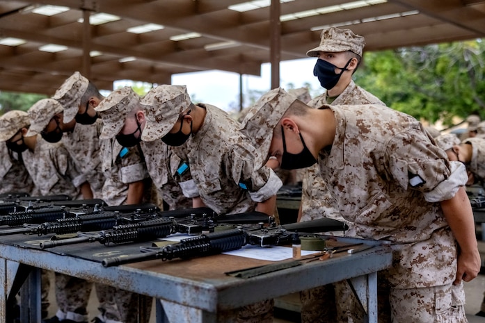 U.S. Marine Corps recruits with Kilo Company, 3rd Recruit Training Battalion, check their rifle serial numbers during an M16A4 service rifle issue at Marine Corps Recruit Depot San Diego, June 12, 2023.