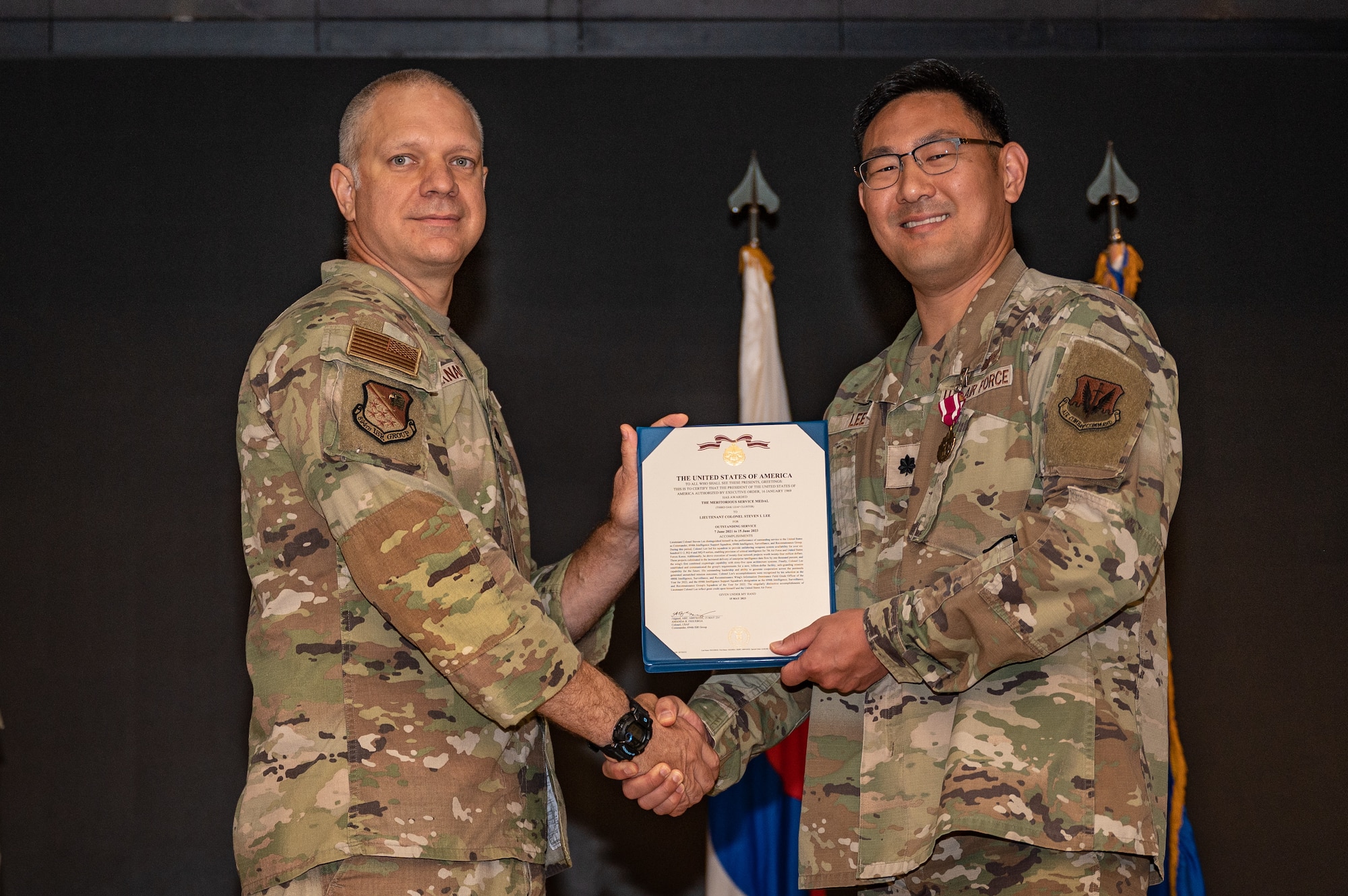 U.S. Air Force Lt. Col. Jarrod Knapp, left, 694th Intelligence, Surveillance, and Reconnaissance Group deputy commander, presents a Meritorious Service Medal to Lt. Col. Steven Lee, 694th Intelligence Support Squadron outgoing commander, at Osan Air Base, Republic of Korea, June 15, 2023. The MSM is a military decoration awarded by various branches of the Armed Forces to recognize distinguished or outstanding meritorious service. (U.S. Air Force photo by Senior Airman Thomas Sjoberg)