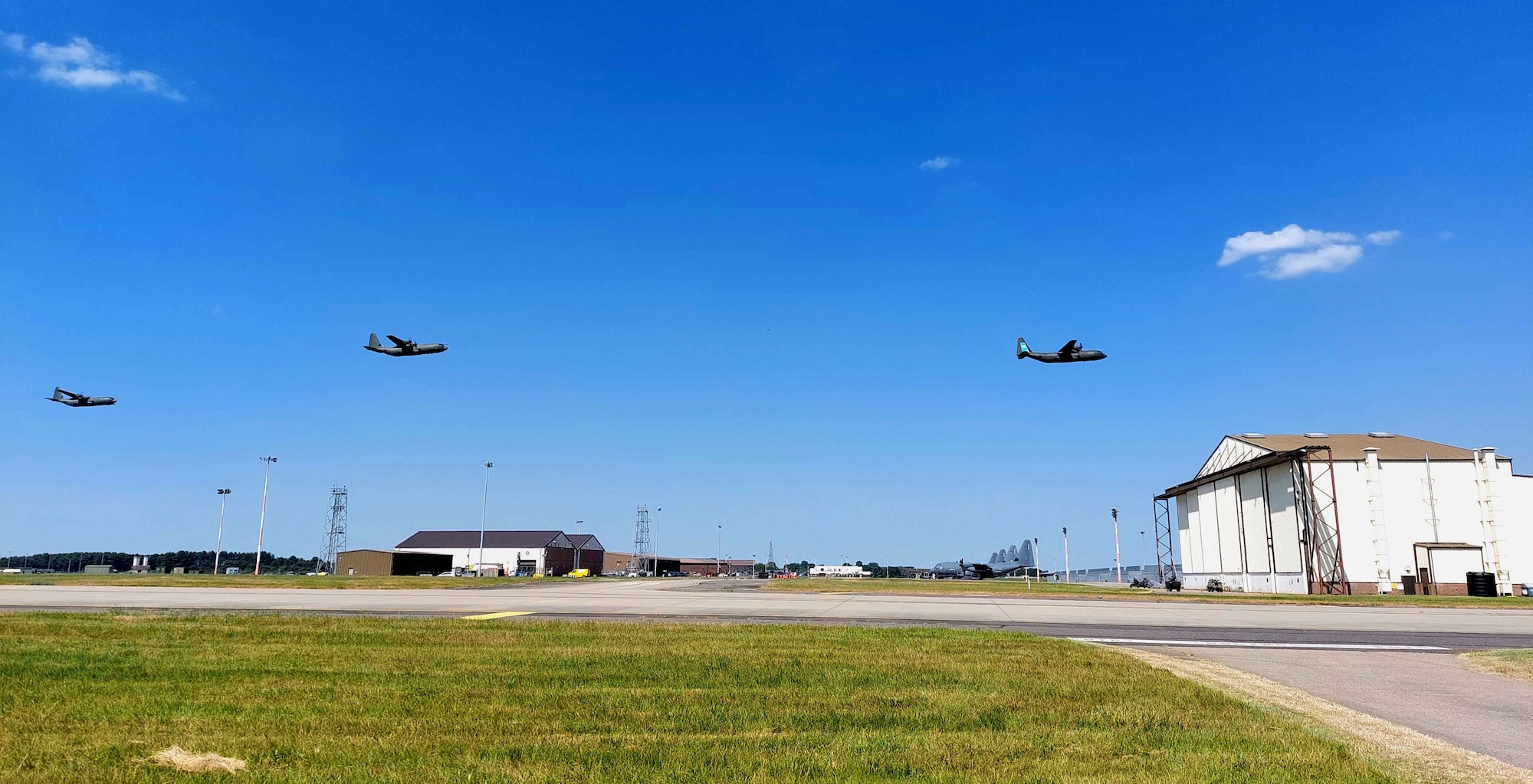 Three Royal Air Force C-130 Hercules aircraft fly over RAF Mildenhall to mark the aircraft’s retirement at RAF Mildenhall, England, June 14, 2023. The C-130 Hercules had been employed for humanitarian relief and global UK military operations since 1966. (Courtesy Photo by Squadron Leader Alexander Bell)
