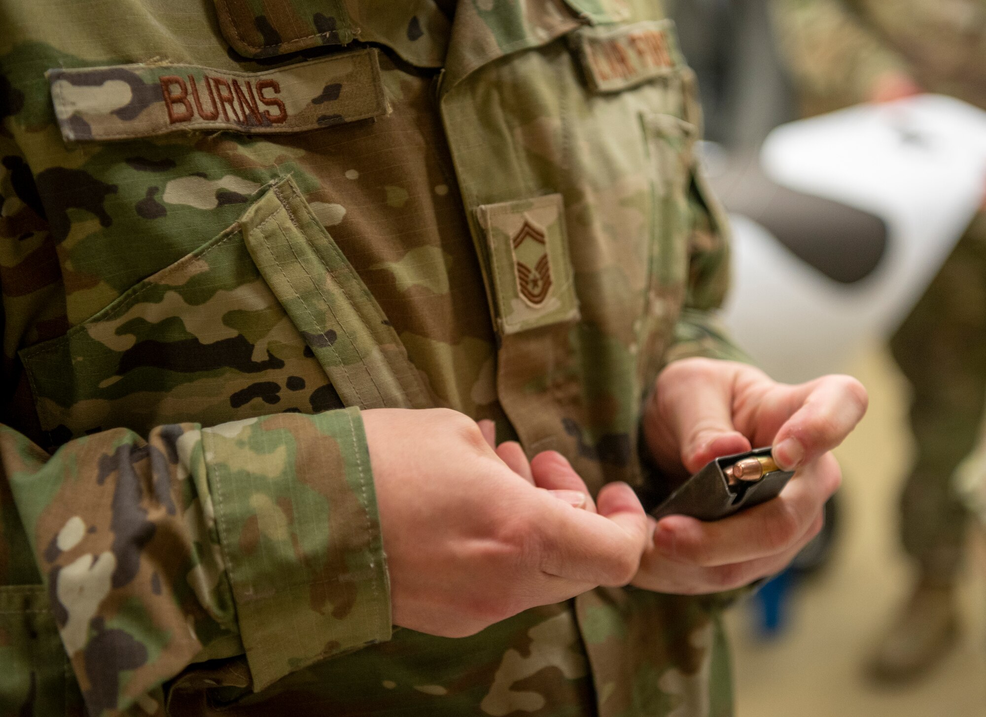 U.S. Air Force Senior Master Sgt. Russell Burns, 51st Force Support Squadron chief of manpower, loads a magazine before competing in the 2023 Police Week Excellence in Competition (EIC) on Osan Air Base, Republic of Korea, May 18, 2023. The Air Force awards EIC badges for excellence in individual competitions only. Points can be earned through competitions held by other services or in the private sector and count as credit toward the award of the appropriate distinguished badge. (U.S. Air Force photo by Airman 1st Class Aaron Edwards)