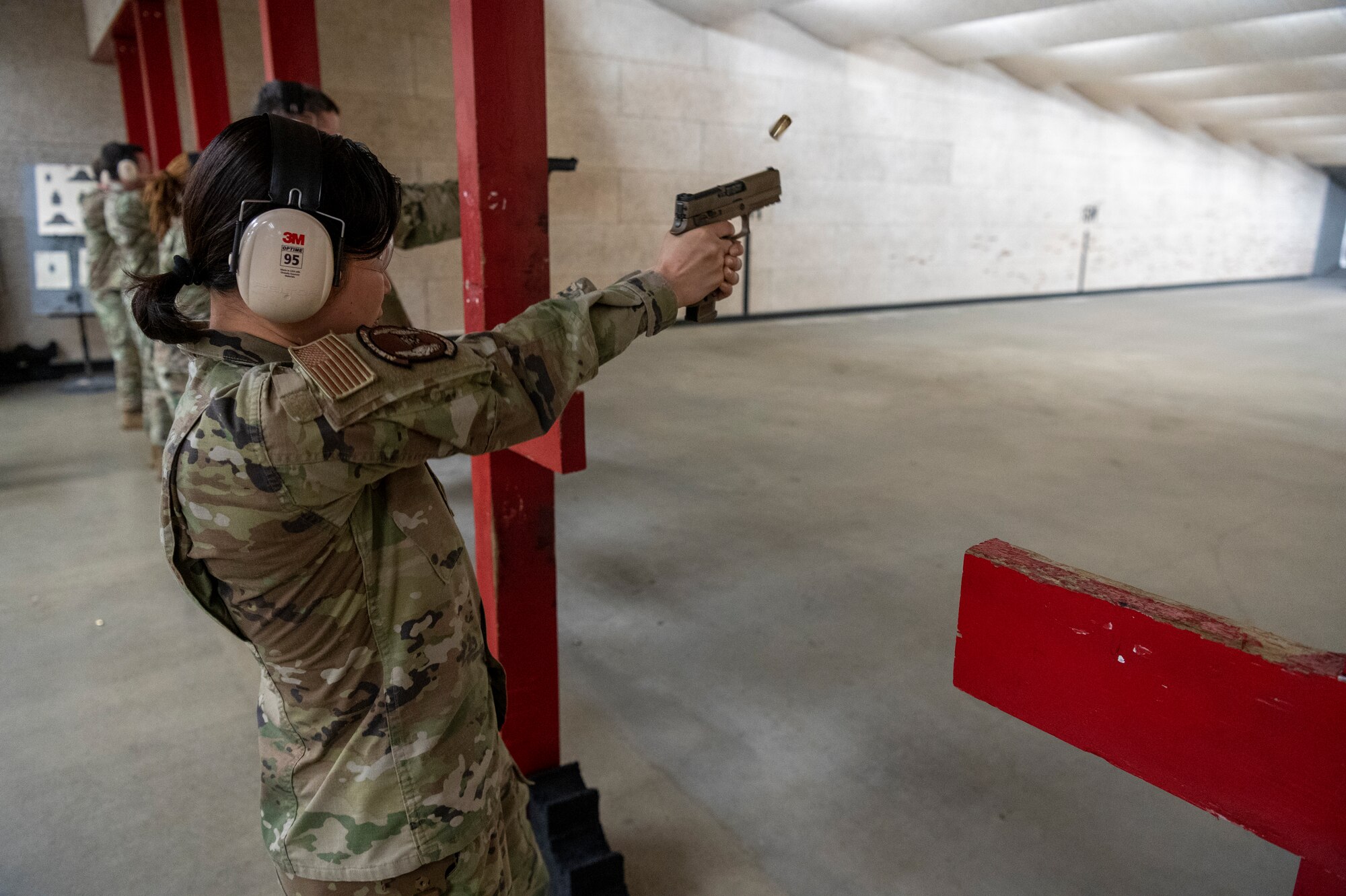 U.S. Air Force Airman 1st Class Sina Sim, 51st Security Forces Squadron alarm monitor, shoots at a target during the 2023 Police Week Excellence in Competition (EIC) on Osan Air Base, Republic of Korea, May 18, 2023. The EIC conducts all matches in accordance with guidelines established by the Civilian Marksmanship Program. The program consists of four different levels of awards an individual can earn, based on excellence in marksmanship for both pistol and rifle. (U.S. Air Force photo by Airman 1st Class Aaron Edwards)