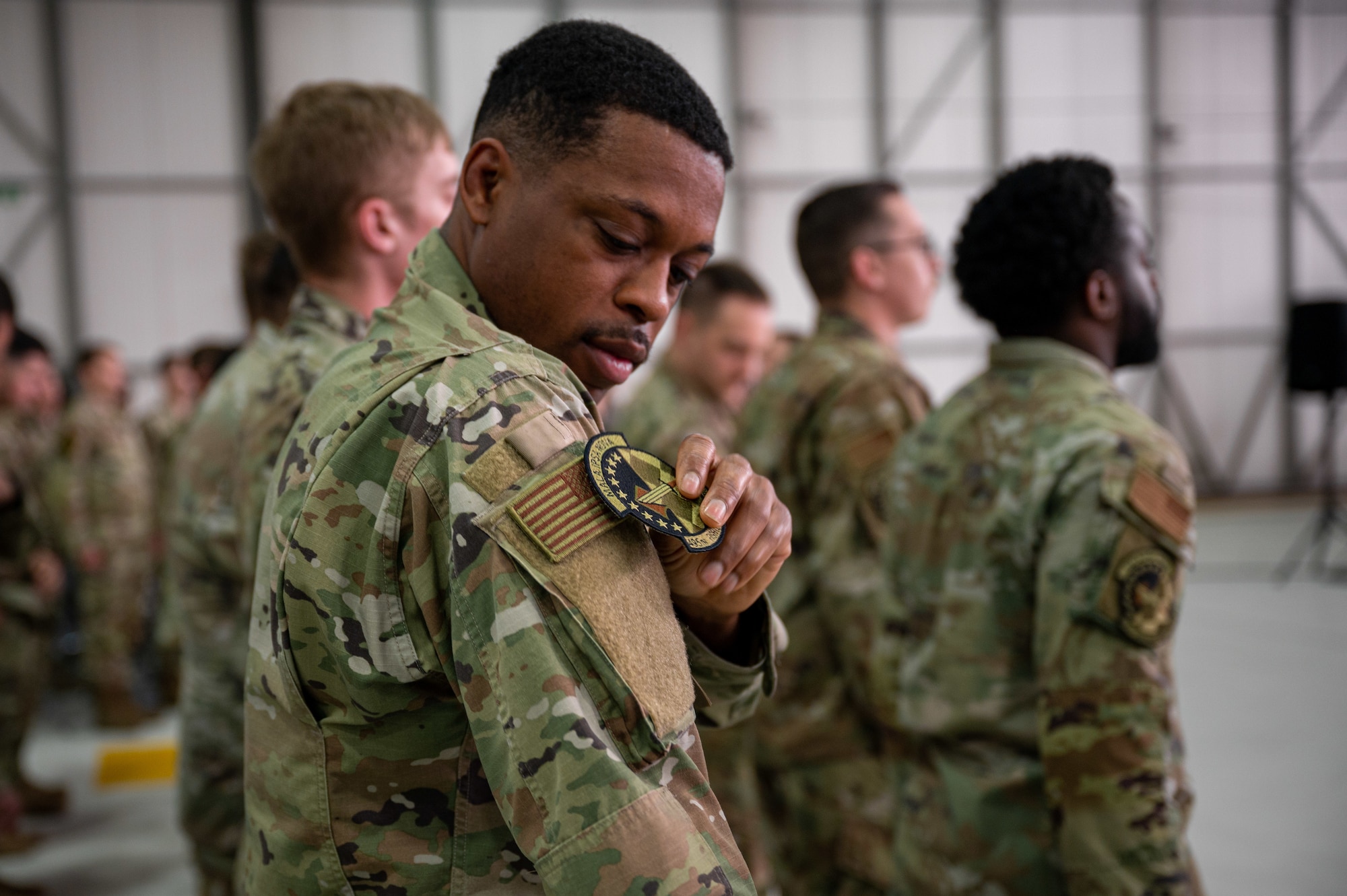 U.S. Air Force Omari Miller, 495th Fighter Generation Squadron F-35 avionics technician, replaces his 748th Aircraft Maintenance Squadron patch with the 495th Fighter Generation Squadron patch, signifying the deactivation and activation of the squadrons at RAF Lakenheath, England, June 9, 2023. The 748th AMXS was succeeded by the 493rd and 495th Fighter Generation Squadrons, establishing the first two Fifth-Generation FGS in the European theater. (U.S. Air Force photo by Airman 1st Class Seleena Muhammad-Ali)