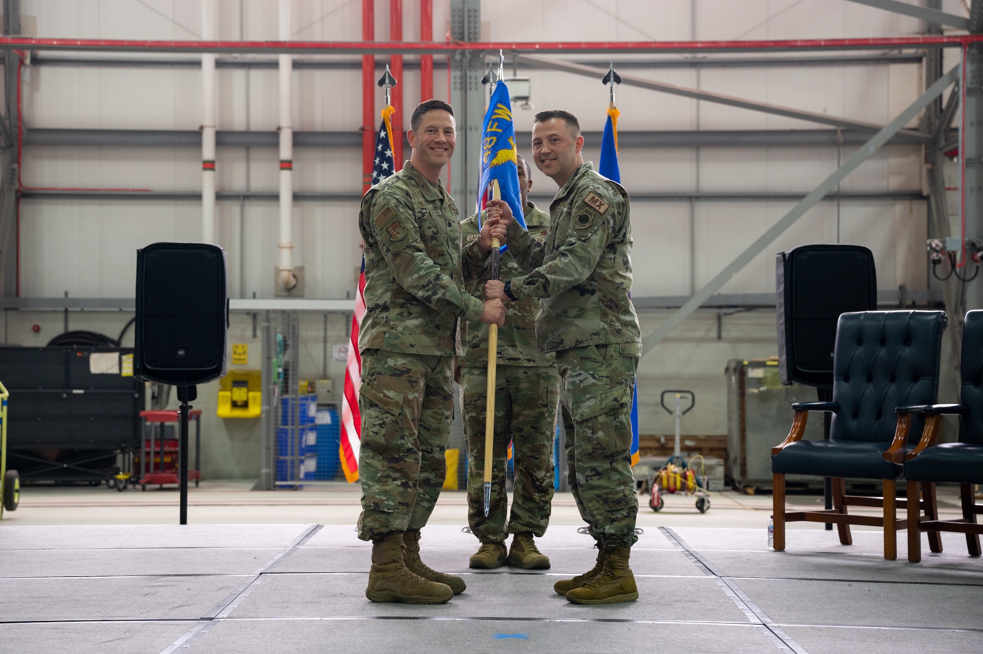U.S. Air Force Lt. Col. James Antone, 48th Maintenance Group deputy commander, left, presents the guidon to Maj. Shaun Chauta, 493rd Fighter Generation Squadron commander, during the 493rd and 495th FGS activation and assumption of command ceremony at RAF Lakenheath, England, June 9, 2023. The activation of the 493rd and 495th FGS is intended to offer squadrons increased control of their assets to meet their mission and manpower requirements. (U.S. Air Force photo by Airman 1st Class Seleena Muhammad-Ali)