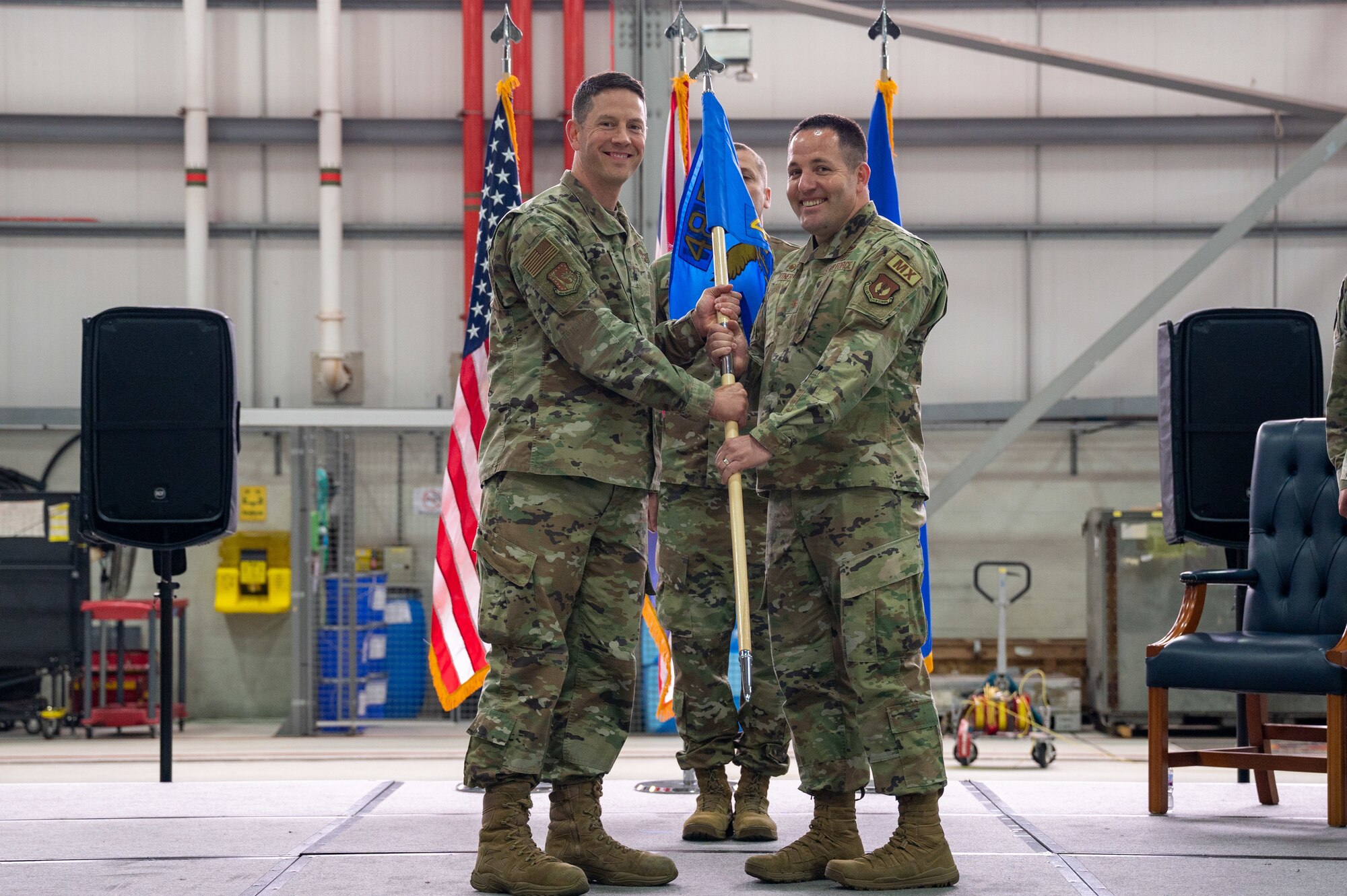 U.S. Air Force Lt. Col. James Antone, 48th Maintenance Group deputy commander, left, presents the guidon to Maj. Stephen Ortner, 495th Fighter Generation Squadron commander, right, during the 493rd and 495th FGS activation and assumption of command ceremony at RAF Lakenheath, England, June 9, 2023. The activation of the 493rd and 495th FGS is intended to offer squadrons increased control of their assets to meet their mission and manpower requirements. (U.S. Air Force photo by Airman 1st Class Seleena Muhammad-Ali)