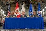 U.S. Air Force Brig. Gen. David Cochran, West Virginia National Guard assistant adjutant general and commander of the West Virginia Air National Guard; David Delmonaco, 12th Air Force (Air Forces Southern) representative, and Lt. Gen. Carlos Chavez, the Peruvian Air Force chief of staff, sign a trilateral agreement of future engagements at the 167th Airlift Wing, Shepherd Field, Martinsburg, West Virginia, June 9, 2023. The signing ceremony signified the commitment to continue military cooperation and operate cohesively in response to future threats and crisis.