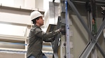 Engineer Chris Snyder checks a piece of equipment during vibration testing at the NAWCAD Lakehurst Environmental Test lab March 7.