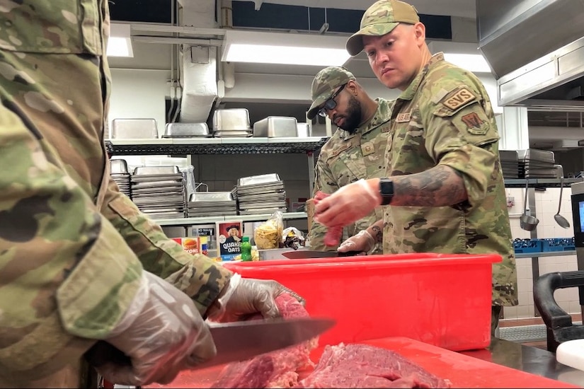 Pennsylvania Air National Guardsmen assigned to the 111th Attack Wing, headquartered at Biddle Air National Guard Base in Horsham, Pennsylvania, prepare food at a dining facility at Joint Base Pearl Harbor-Hickam, Hawaii, June 12, 2023, during a two-week training exercise known as Koa Lani. The goal of the Koa Lani exercise was to simulate the logistics and operation tempo involved with deploying to an airbase overseas in support of an active-duty contingency operation. (Air National Guard photo by Staff Sgt. Wilfredo Acosta)