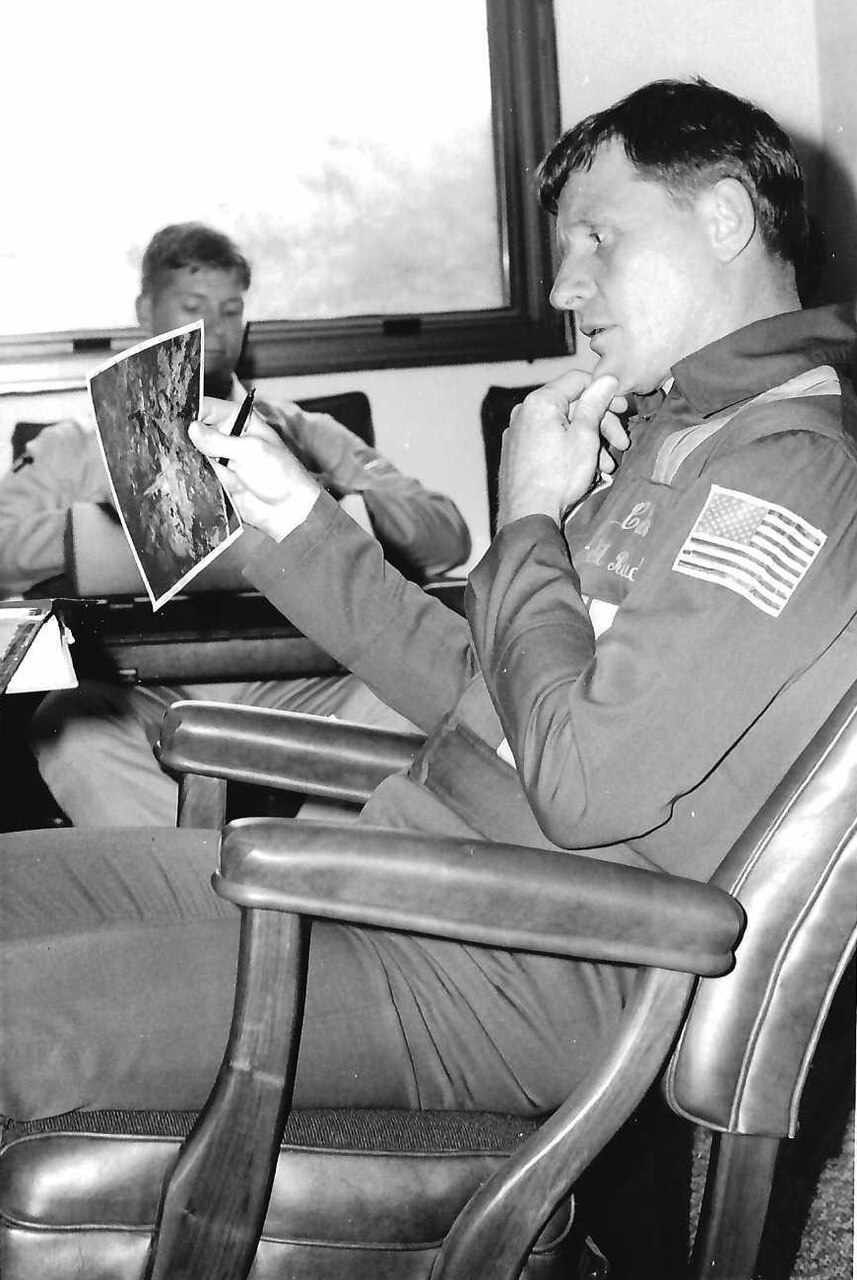 Cmdr. Rud studies a pre-show photo of area ground features before an air show at Naval Air Station Oceana, Virginia, in September 1987.