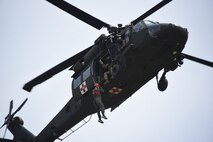 A U.S. Army UH-60 Black Hawk helicopter from the Iowa National Guard’s C Company, 2/211 General Aviation Support Battalion, extracts a downed pilot from the Iowa Air Guard’s 185th Air Refueling Wing during a training exercise near Homer, Nebraska, June 16, 2023.