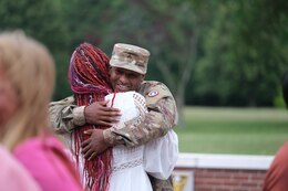 A Soldier reunites with his wife after a 6-month deployment to the Middle East.