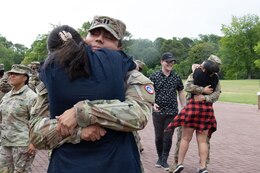 families embrace after returning from a deployment