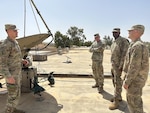 U.S. Army Reserve Capt. Devin Lajoie and Chief Warrant Officer 2 Matthew Morgan with the 1st Theater Sustainment Command Alternate Command Post G6 brief the capabilities of the SIPR/NIPR Access Point antenna and Proliferated Low Earth Orbit satellite system to the 1st TSC ACP director, Col. Gerry Jackson, and noncommissioned officer in charge, Sgt. 1st Class Jeffrey Chandler.
