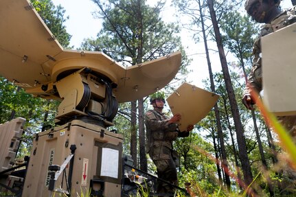 Sgt. Isall Lantigua, left, and Spc. Thedly Toussaint, signal support specialists assigned to C Company, 104th Brigade Engineer Battalion, 44th Infantry Brigade Combat Team, New Jersey Army National Guard, assemble a satellite dish that provides internet connectivity for the battalion during a rotation at the Joint Readiness Training Center at Fort Johnson, Louisiana, June 5, 2023.