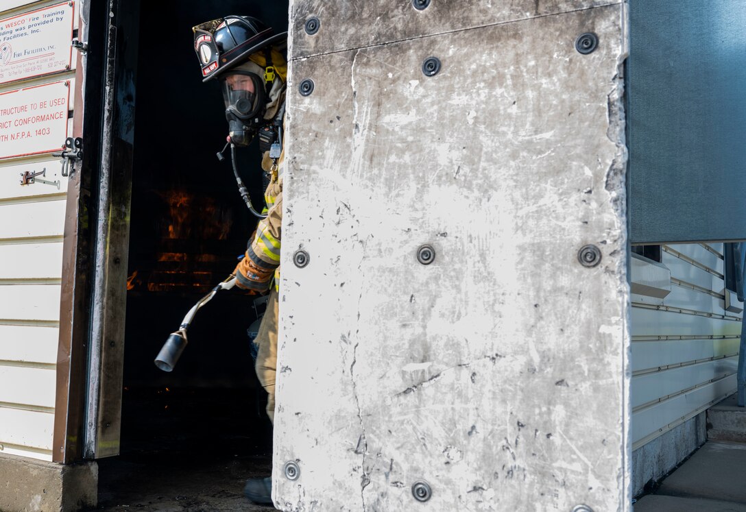 U.S. Air Force Staff Sgt. Jacob East, 28th Civil Engineer Squadron fireman, participates in a structural fire exercise at Ellsworth Air Force Base, South Dakota, June 13, 2023.