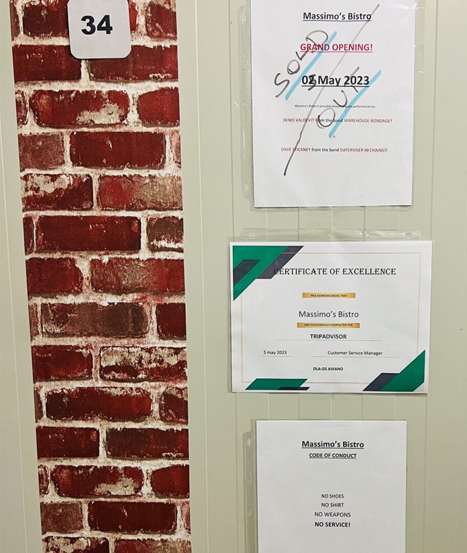 Signs on a wall outside a breakroom.