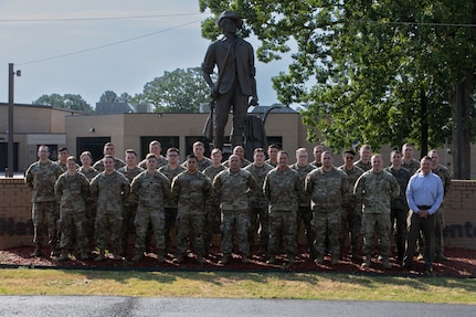 Iowa National Guardsmen participating in Cyber Shield pose with one of their civilian counterparts and one Kosovo soldier from their State Partnership Program in front of the Minuteman statue at The Professional Educational Center, Little Rock, Ark., June 8, 2023. Approximately 800 National Guard and Army Reserve Soldiers, Airmen, Sailors, and civilian cyber professionals from around the world gathered during this year’s Cyber Shield training exercise.