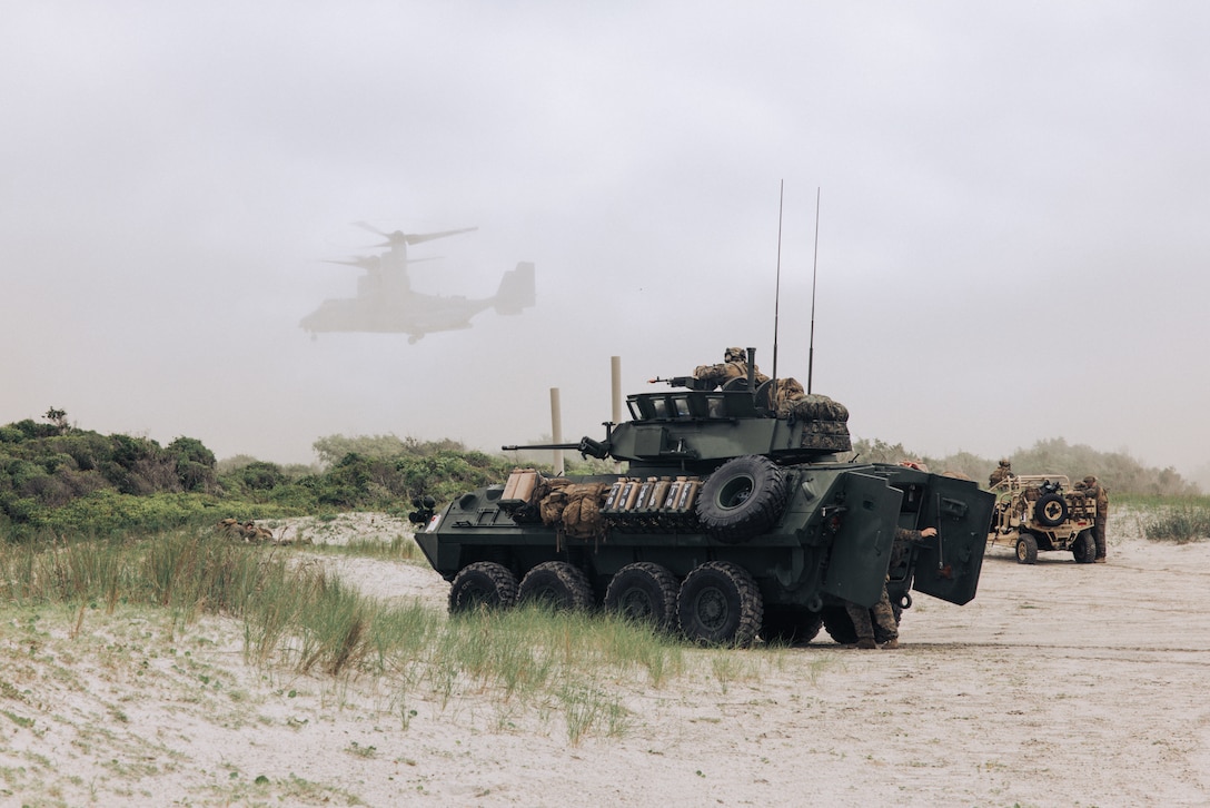 A U.S. Marine Corps Light Armored Vehicle with the 26th Marine Expeditionary Unit provides security for aerial insertion while executing an amphibious assault during Composite Training Unit Exercise on Marine Corps Base Camp Lejeune, North Carolina, June 2, 2023. The amphibious assault rehearsed the utilization of Marines to move from ship to shore and secure objectives for follow-on actions. C2X is the last exercise in the pre-deployment training program for the Bataan Amphibious Ready Group.