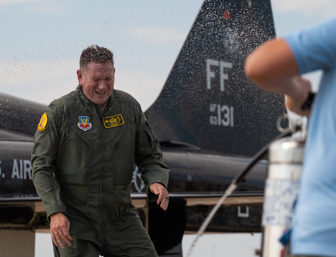 Col. Creeden completes his fini flight with his family, friends, and fellow commanders.