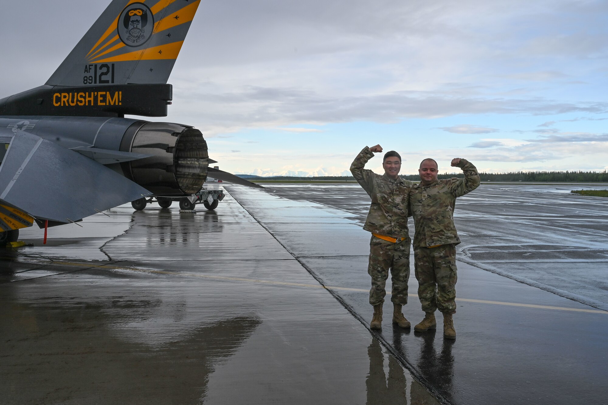 U.S. Air Force Master Sgt. Carleton Kennedy, left, 80th Fighter Generation Squadron production supervisor, and Capt. Sung Woo Suh, 80th FGS Director of Operations, pose for a photo in front of an F-16 Fighting Falcon assigned to the 80th Fighter Squadron at Eielson Air Force Base Alaska, June 13, 2023. While deployed to Eielson in support of RED FLAG-Alaska, Suh and Kennedy were recognized for saving an infant, father and dog from drowning and hypothermia when their kayak capsized in Chena Lake Recreation Area, Alaska on June 3, 2023.(U.S. Air Force photo by Airman Carson Jeney)